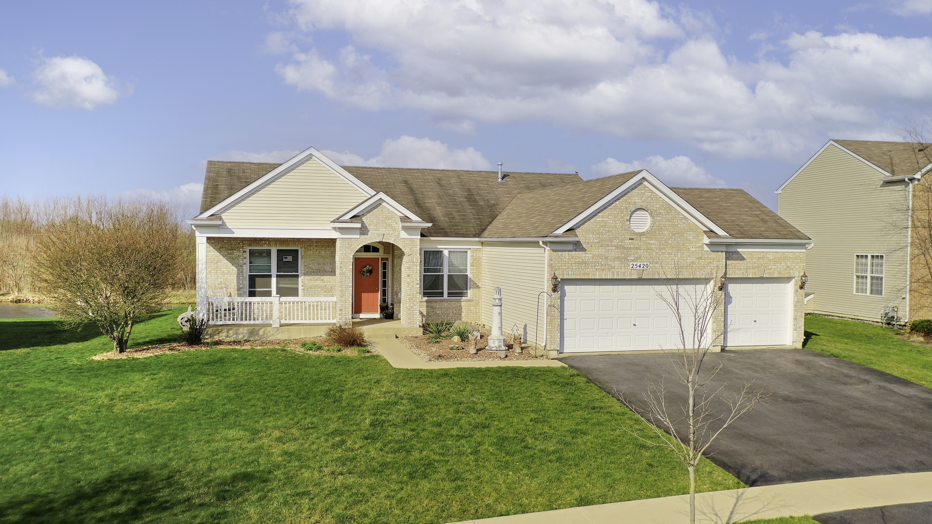 25420 Spring Street Manhattan, IL 60442 - Photo 27 of 27 a front view of a house with a yard and garage
