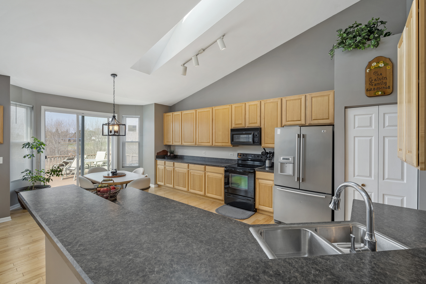25420 Spring Street Manhattan, IL 60442 - Photo 9 of 27 a kitchen with granite countertop a sink stainless steel appliances and a counter top space