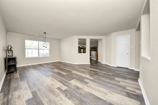 a view of empty room with furniture and window
