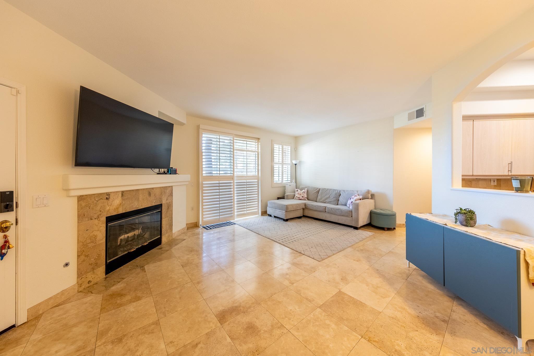 11969 Tivoli Park Row, Unit 4 San Diego, CA 92128 - Photo 1 of 18 a living room with furniture and a flat screen tv