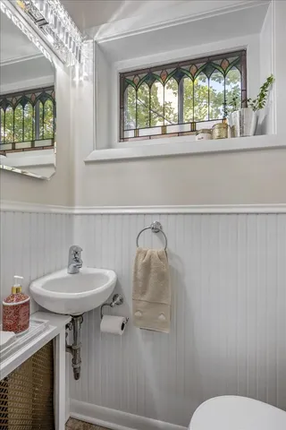 a bathroom with a sink a mirror and a toilet