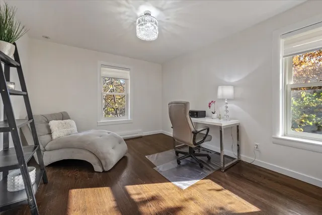 a view of a workspace with furniture and a window