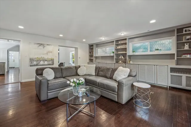 a living room with furniture and wooden floor