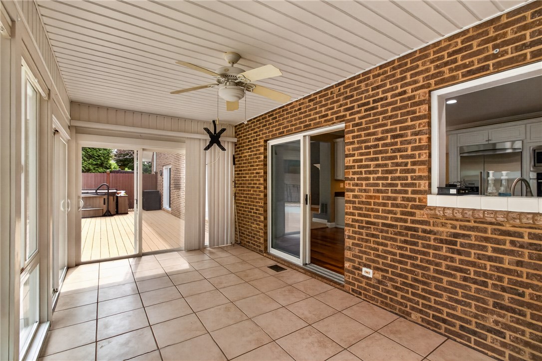 106 Newington Circle Anderson, SC 29621 - Photo 12 of 27 This bright sunroom with a ceiling fan opens to a deck with a spa.
