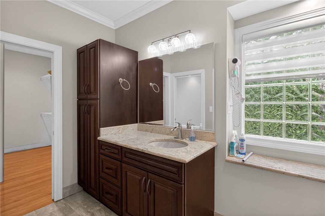 106 Newington Circle Anderson, SC 29621 - Photo 17 of 27 This bathroom features elegant cabinetry and a bright window, creating a refreshing atmosphere.