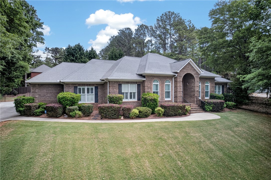 106 Newington Circle Anderson, SC 29621 - Photo 2 of 27 This classic brick residence features a lush lawn and manicured landscaping.