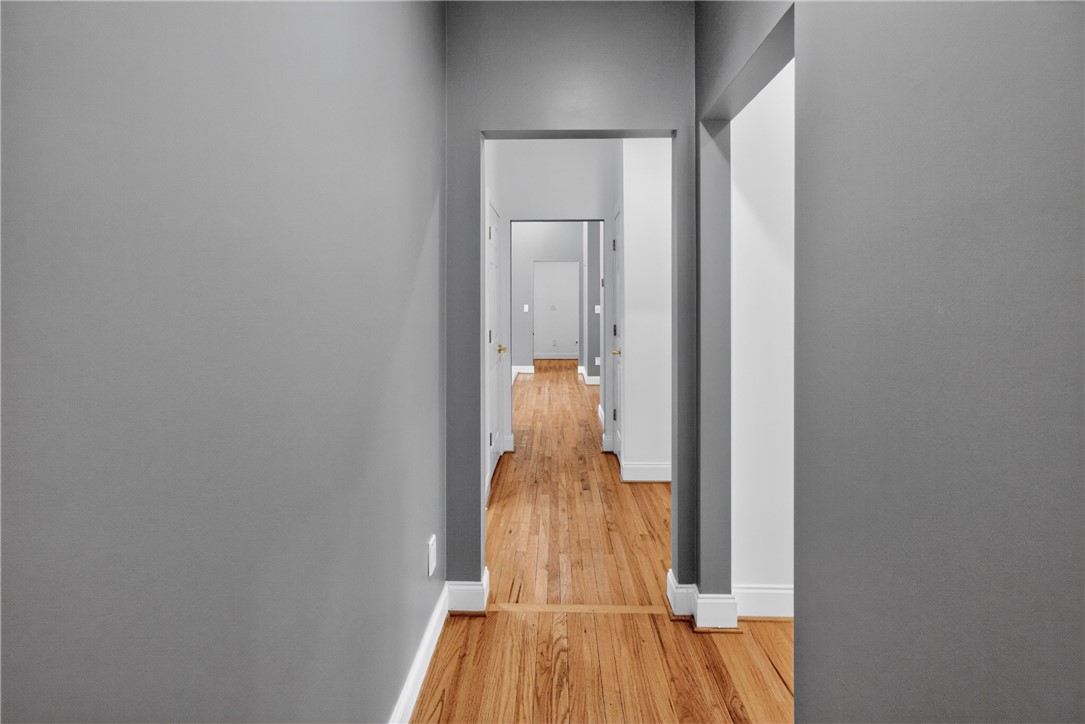 106 Newington Circle Anderson, SC 29621 - Photo 23 of 27 This spacious hallway features gleaming hardwood floors leading to various rooms, ideal for effortless flow.