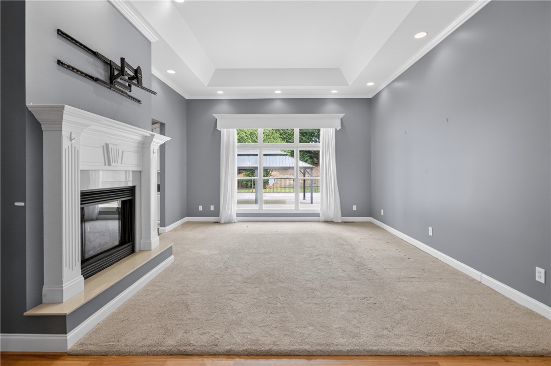 106 Newington Circle Anderson, SC 29621 - Photo 7 of 27 This inviting living space features a fireplace, plush carpeting, and a bright window with outdoor views.