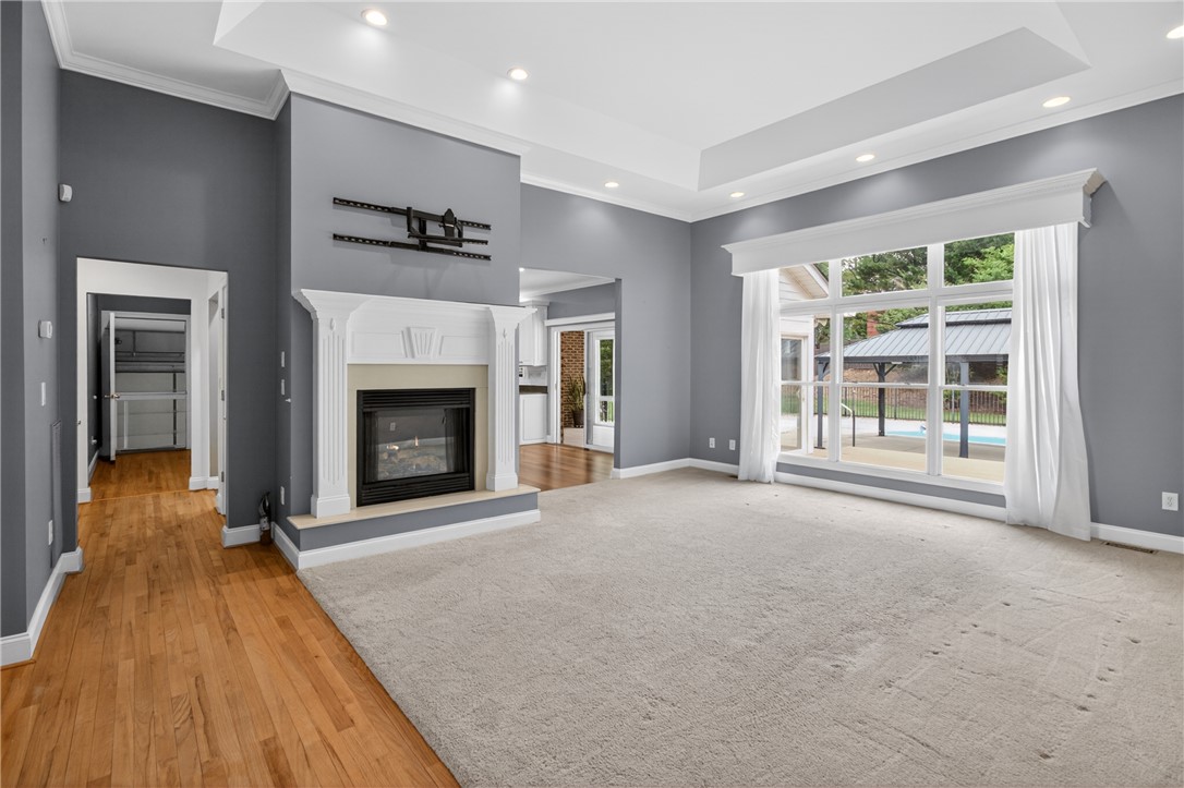 106 Newington Circle Anderson, SC 29621 - Photo 9 of 27 This inviting living space features a cozy fireplace, abundant natural light, and elegant ceiling details.