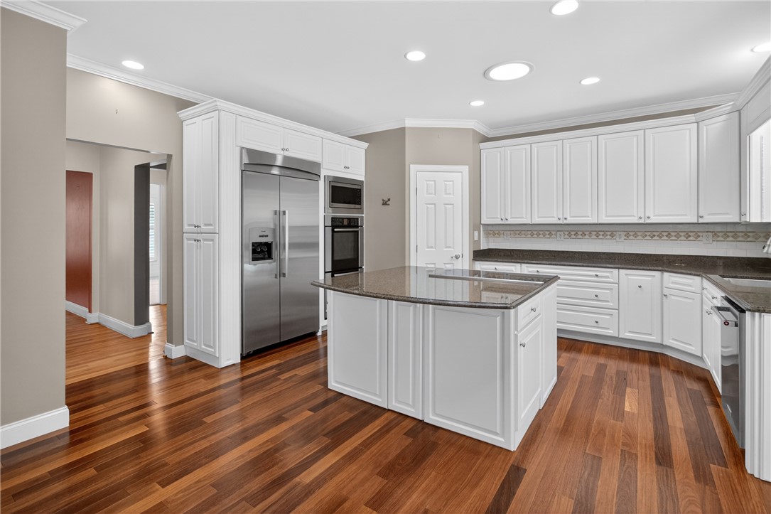 106 Newington Circle Anderson, SC 29621 - Photo 10 of 27 This bright kitchen features sleek appliances, an island, and rich hardwood flooring, perfect for daily living.