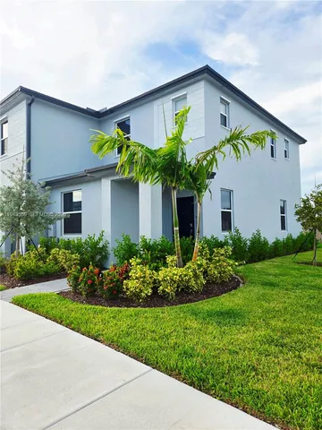 a front view of house with a garden and plants