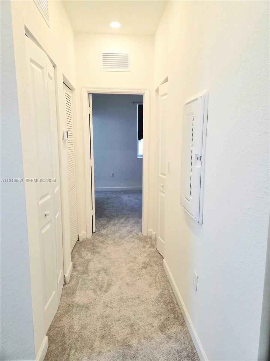 17925 Southwest 358th Street Homestead, FL 33034 - Photo 14 of 25 a view of a hallway with wooden floor and closet