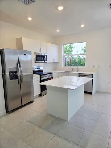 a view of a kitchen with a sink and a window