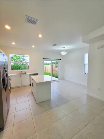 a kitchen with kitchen island cabinets and appliances