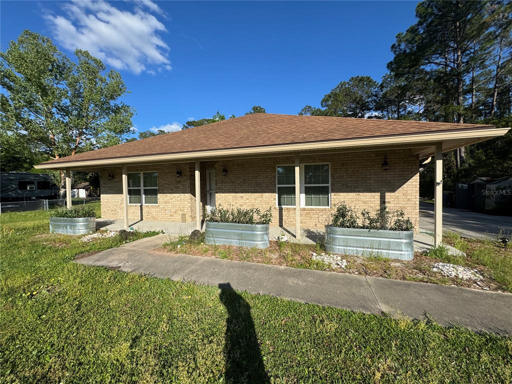 54292 Armstrong Road Callahan, FL 32011 - Photo 1 of 1 a view of a house with backyard porch and sitting area