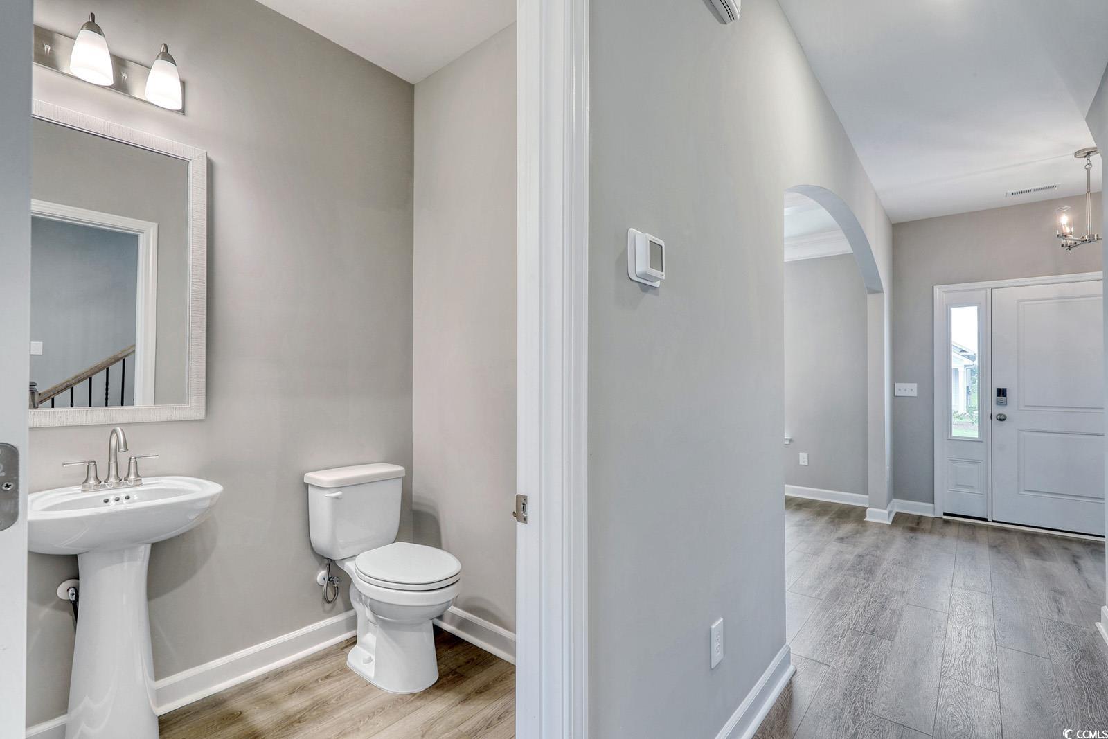 4035 Bucolic Loop Myrtle Beach, SC 29588 - Photo 36 of 39 Half bathroom featuring wood finished floors and t