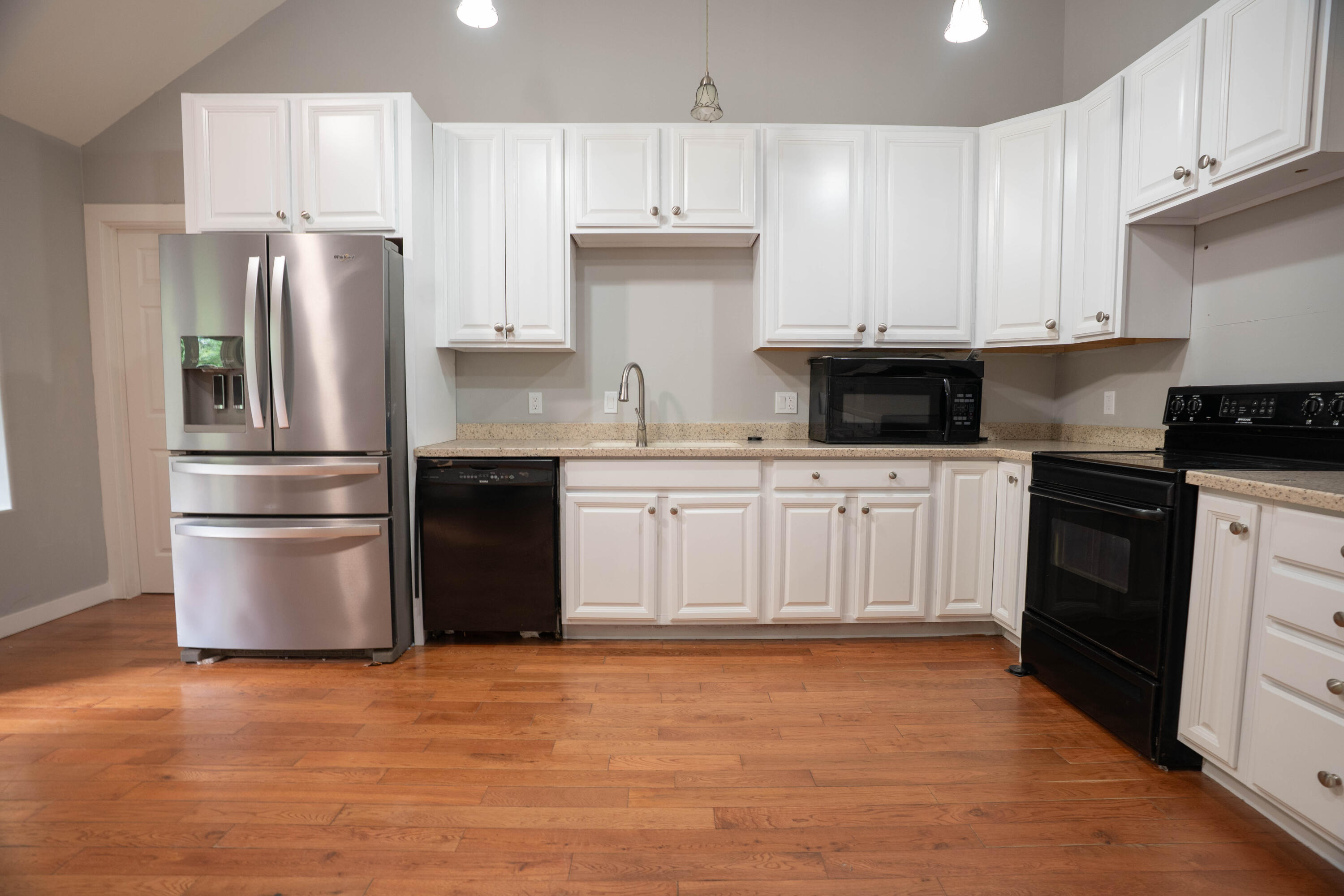 709 Pinewood Way Cave Junction, OR 97523 - Photo 7 of 24 a kitchen with a sink a refrigerator and cabinets