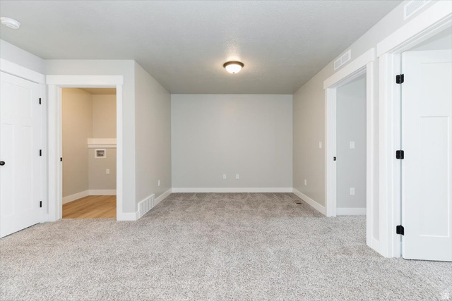 226 South 600 West Logan, UT 84321 - Photo 11 of 25 Spare room featuring light colored carpet and a smoke detector