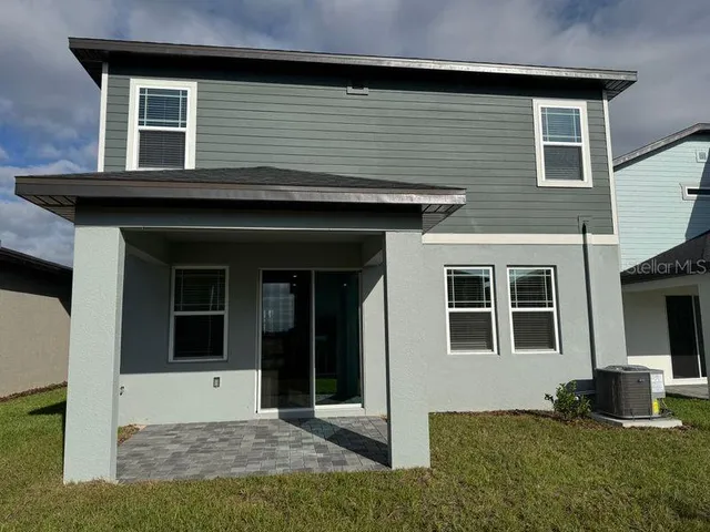 a front view of a house with a garden and plants
