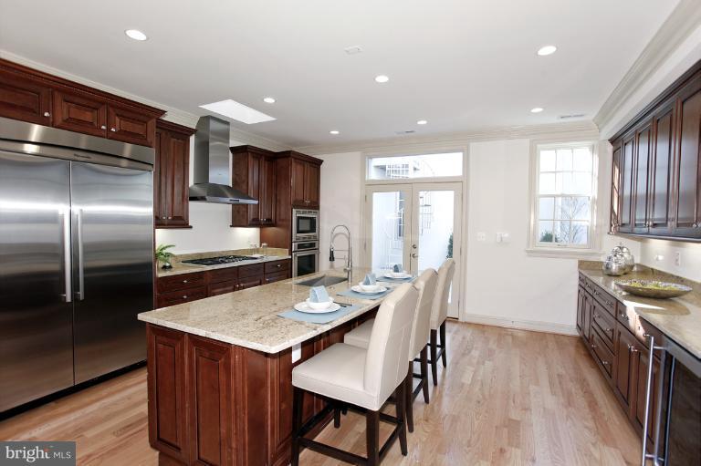 18 7th Street Northeast Washington, DC 20002 - Photo 18 of 27 a kitchen with kitchen island granite countertop a sink stove and refrigerator