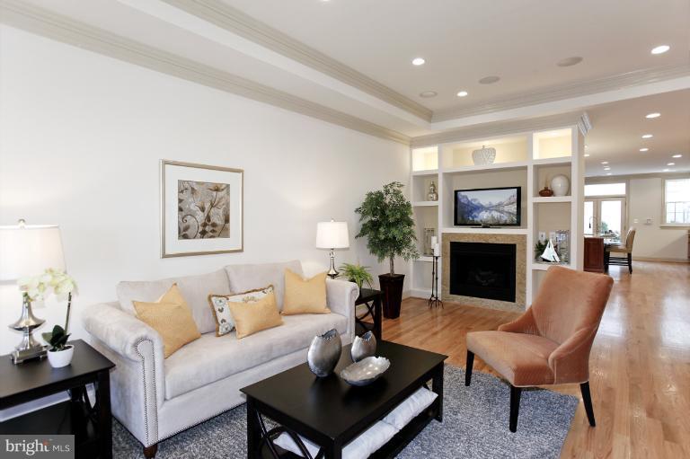 18 7th Street Northeast Washington, DC 20002 - Photo 7 of 27 a living room with furniture a fireplace and a table