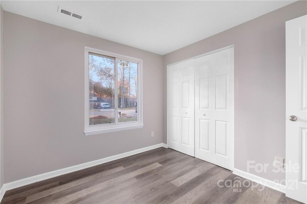 6217 Hickory Ridge Lane Charlotte, NC 28227 - Photo 12 of 15 a view of an empty room with wooden floor and a window