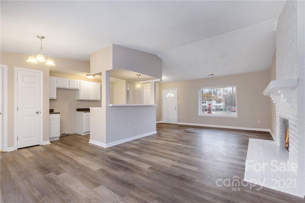 6217 Hickory Ridge Lane Charlotte, NC 28227 - Photo 7 of 15 a view of empty room with wooden floor and fireplace