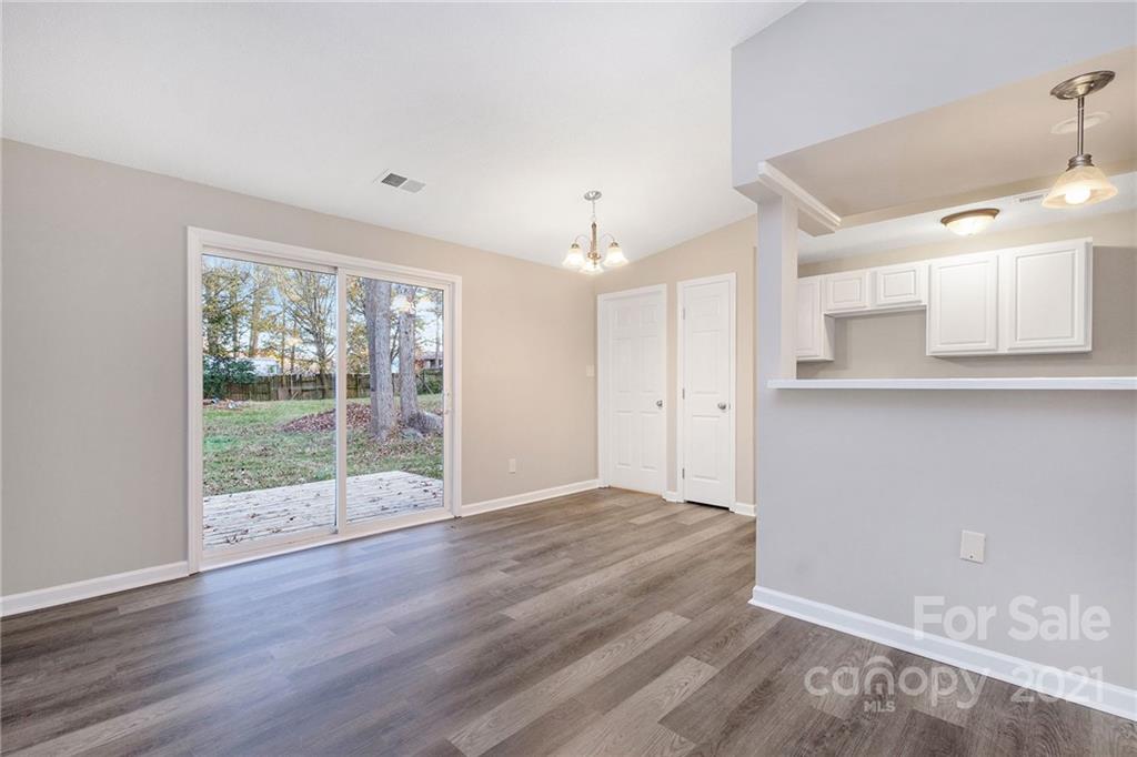 6217 Hickory Ridge Lane Charlotte, NC 28227 - Photo 8 of 15 a view of a kitchen with wooden floor and a large window