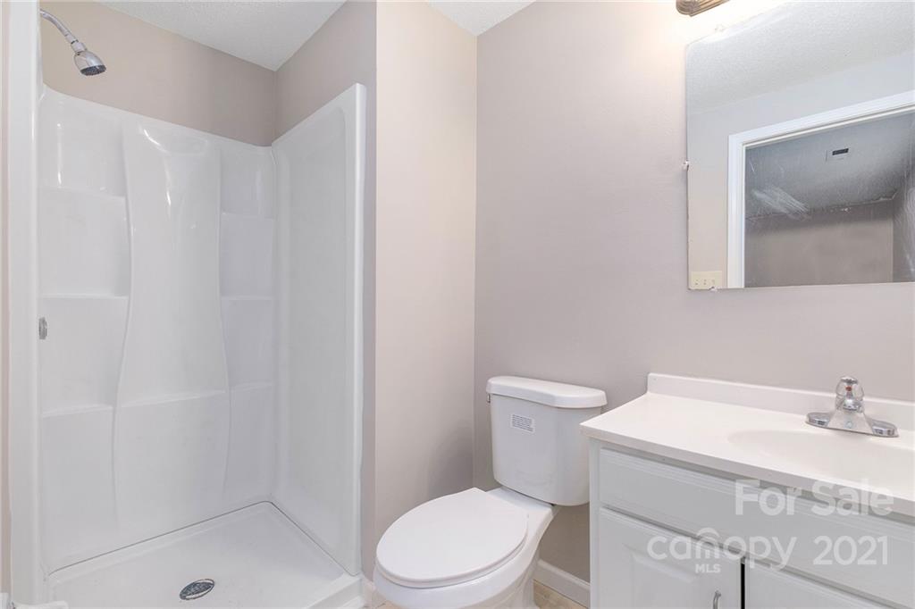 6217 Hickory Ridge Lane Charlotte, NC 28227 - Photo 9 of 15 a white toilet sitting next to a bathroom sink