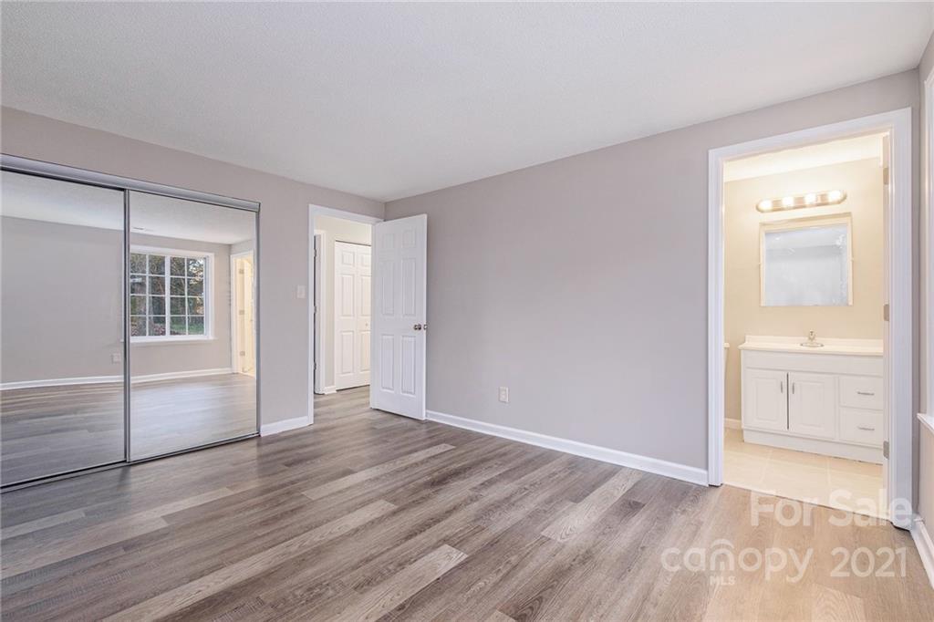 6217 Hickory Ridge Lane Charlotte, NC 28227 - Photo 10 of 15 wooden floor in an empty room with a window
