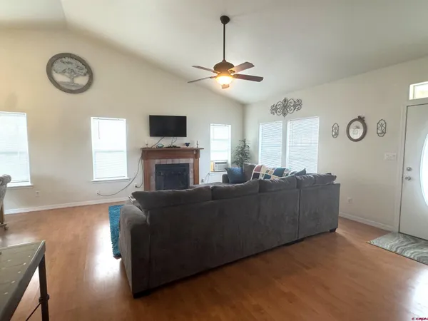 a living room with furniture a fireplace and a flat screen tv