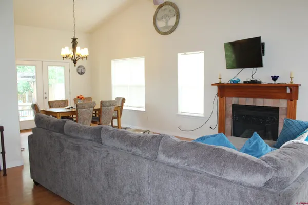 a living room with furniture a fireplace and a flat screen tv