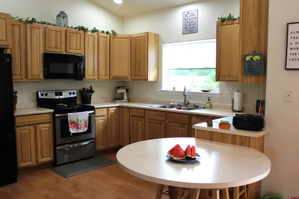 a kitchen with a sink a stove and a microwave