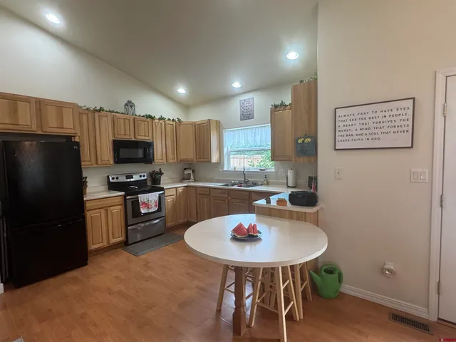 a kitchen with a sink a kitchen island and stainless steel appliances