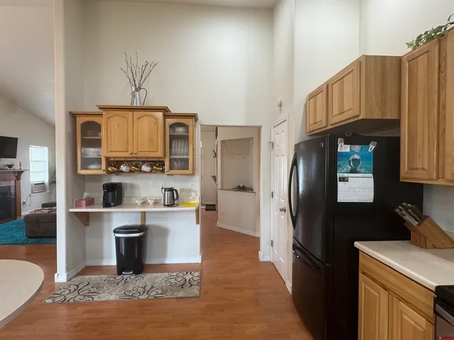 a kitchen with stainless steel appliances granite countertop a refrigerator a stove top oven a sink and dishwasher