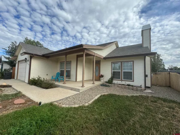 a front view of a house with yard patio and green space