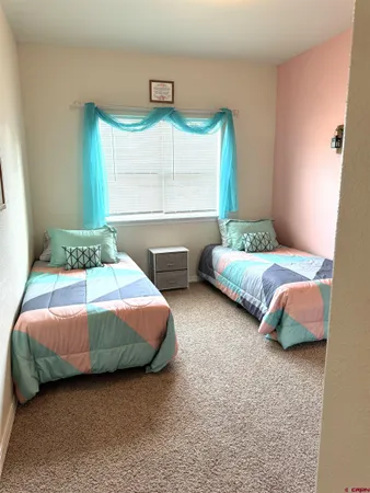 a bedroom with two beds and painted walls