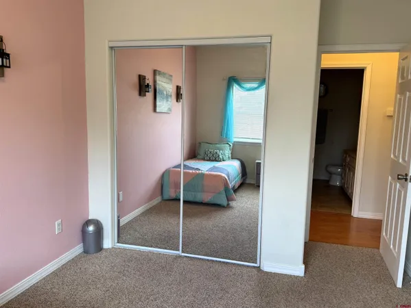 a bedroom with a bed and a view of bathroom