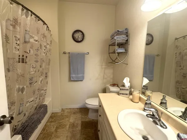 a bathroom with a sink mirror and toilet
