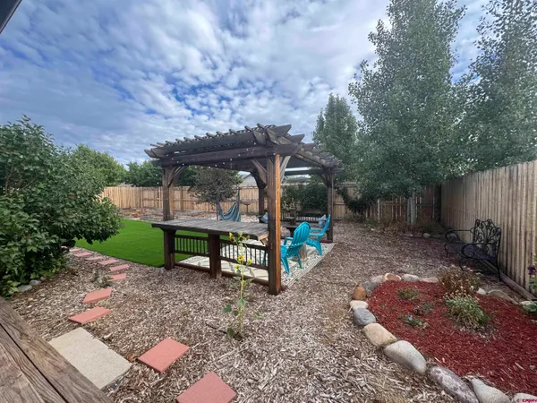 a view of a patio with a table and chairs