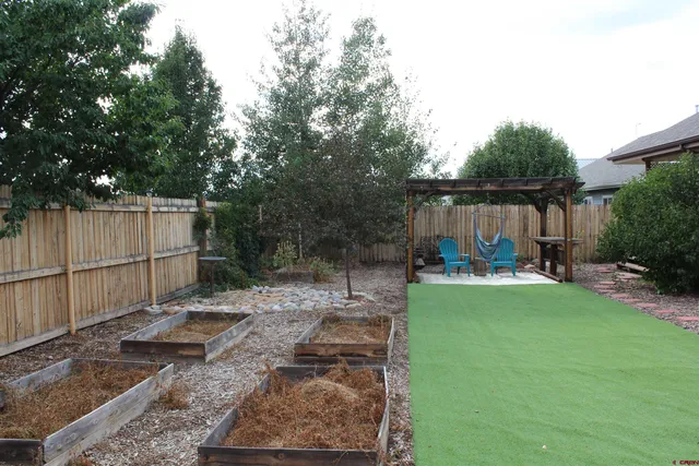 a view of a backyard with sitting area