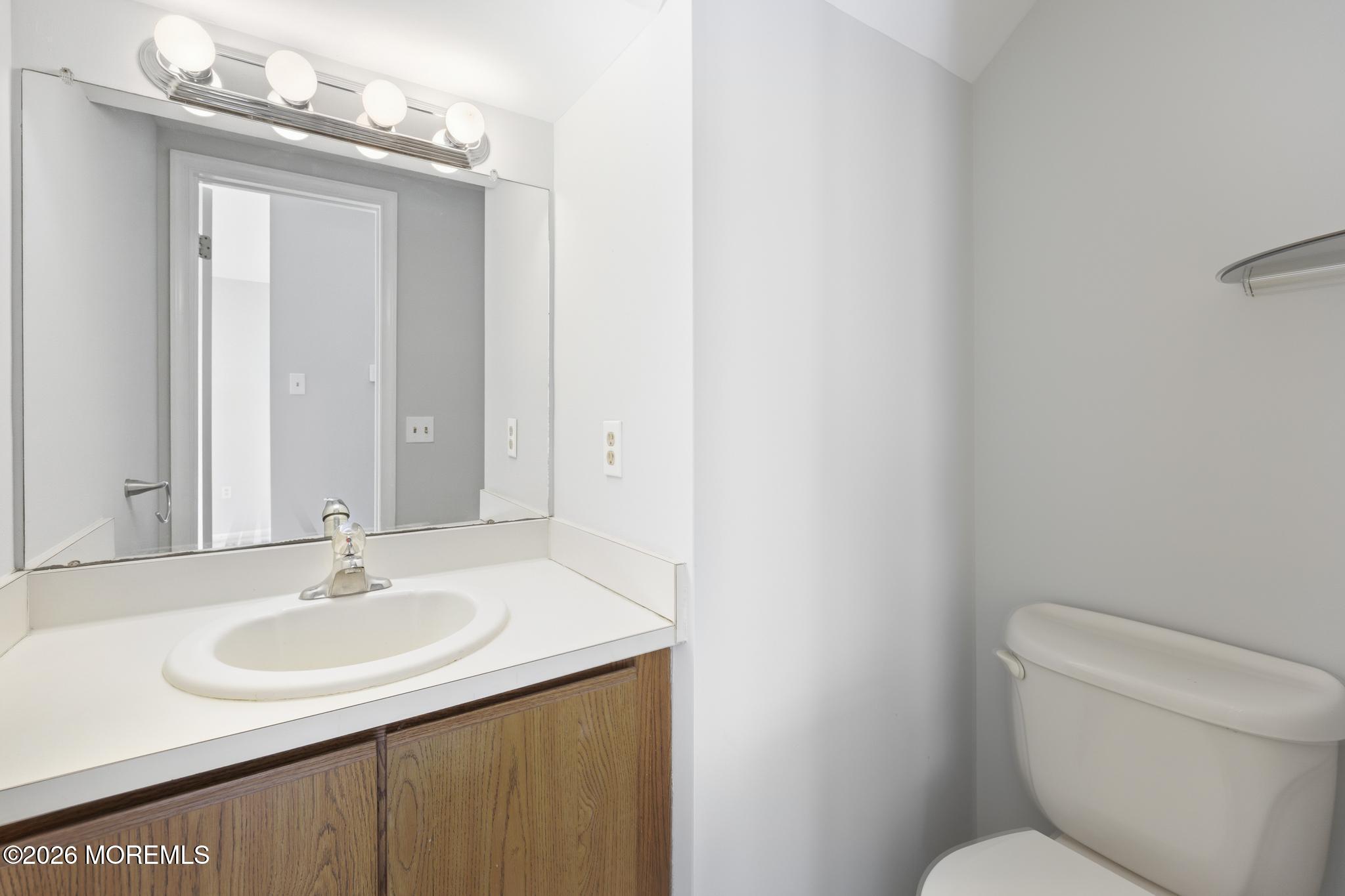 2305 Gulfstream Way Toms River, NJ 08755 - Photo 24 of 42 a bathroom with a sink toilet and a mirror