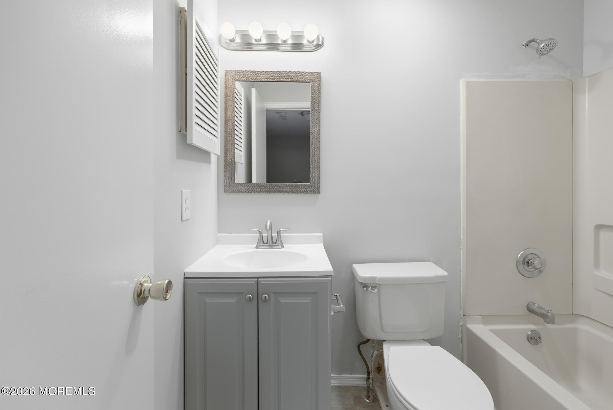 2305 Gulfstream Way Toms River, NJ 08755 - Photo 30 of 42 a bathroom with a toilet a sink and mirror