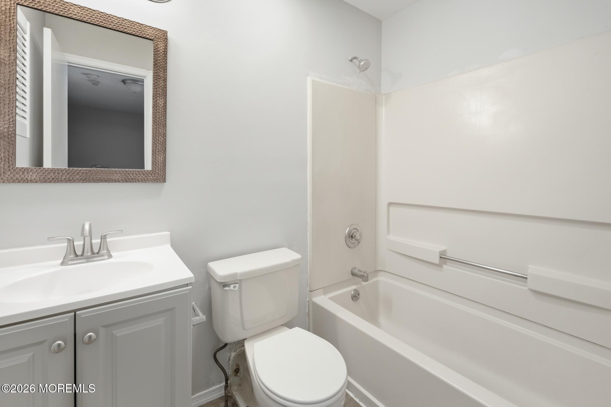 2305 Gulfstream Way Toms River, NJ 08755 - Photo 31 of 42 a bathroom with a toilet a sink a mirror and vanity