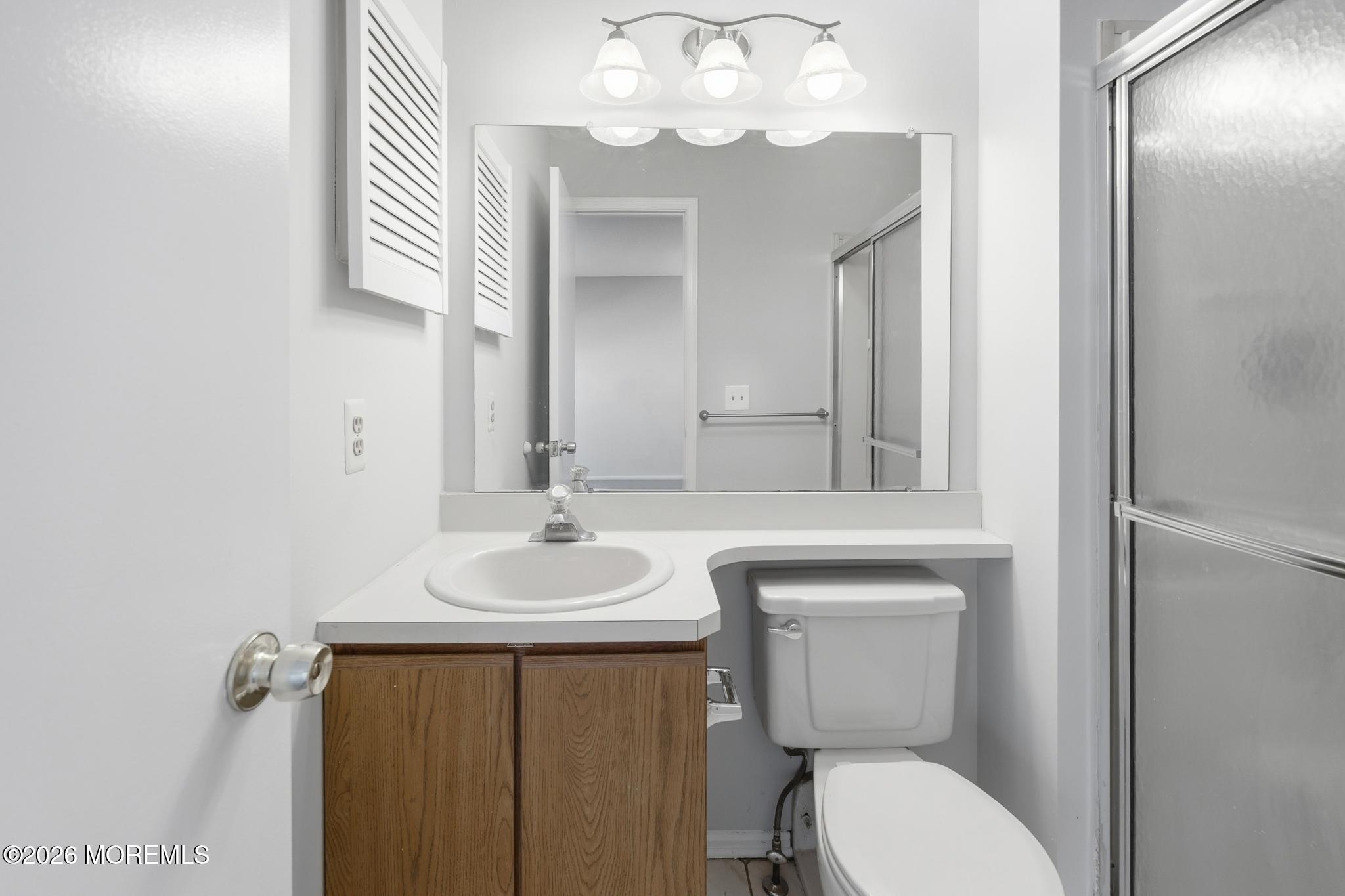 2305 Gulfstream Way Toms River, NJ 08755 - Photo 36 of 42 a bathroom with a toilet a sink and mirror