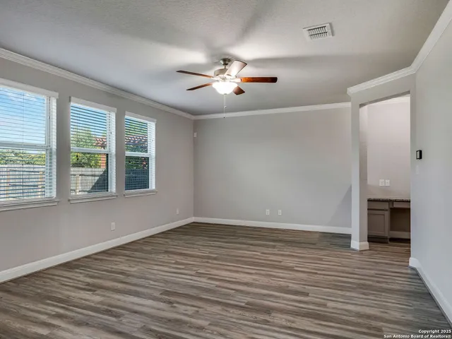 wooden floor in an empty room with a window