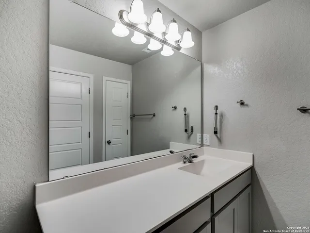 a bathroom with a sink and a mirror