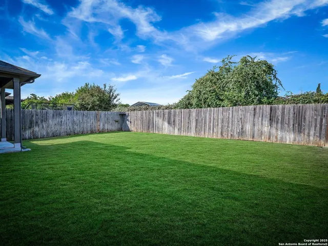 a view of a backyard with a swing
