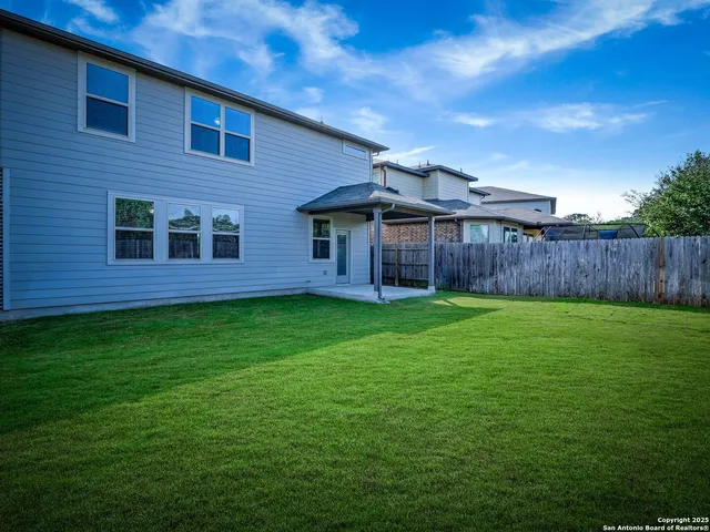 a view of a brick house with a yard
