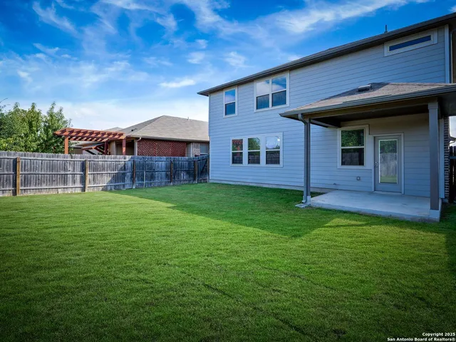 a view of a house with a backyard